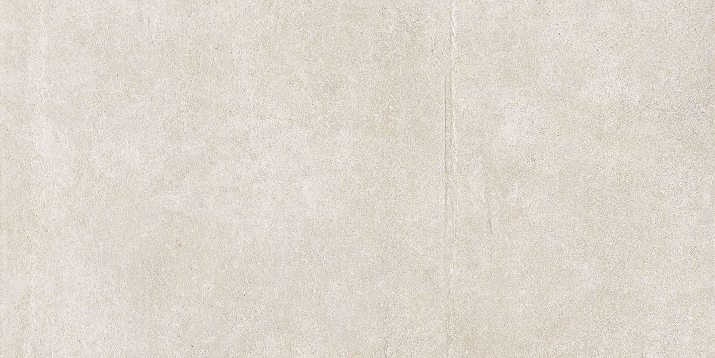 Cremefarbene Fliese mit dezenter Struktur.