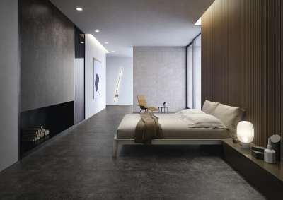 Modernes Schlafzimmer mit dunklen Boden- und Wandfliesen, minimalistisch eingerichtet.