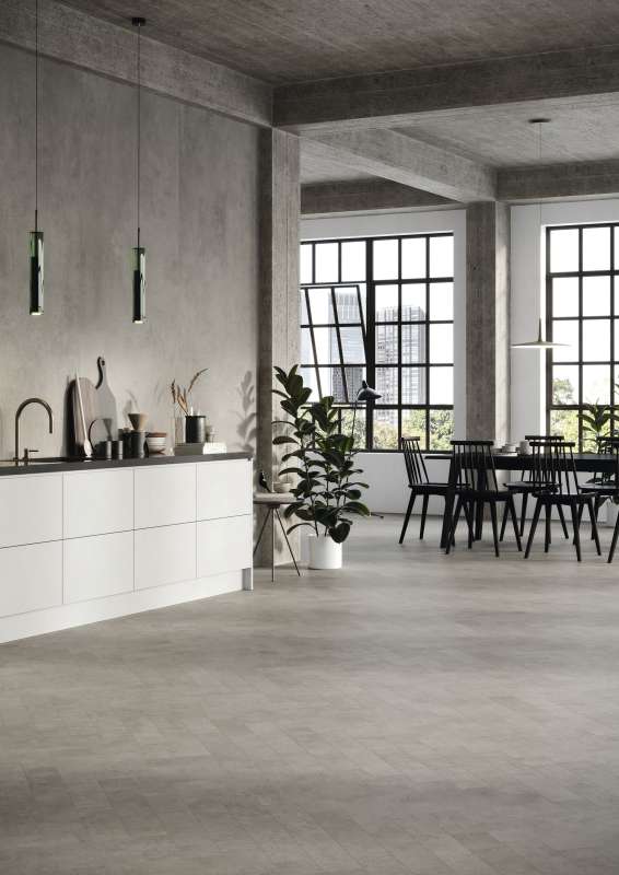 Graue Fliesen im Beton-Look für einen modernen Loft-Stil in Küche und Essbereich.
