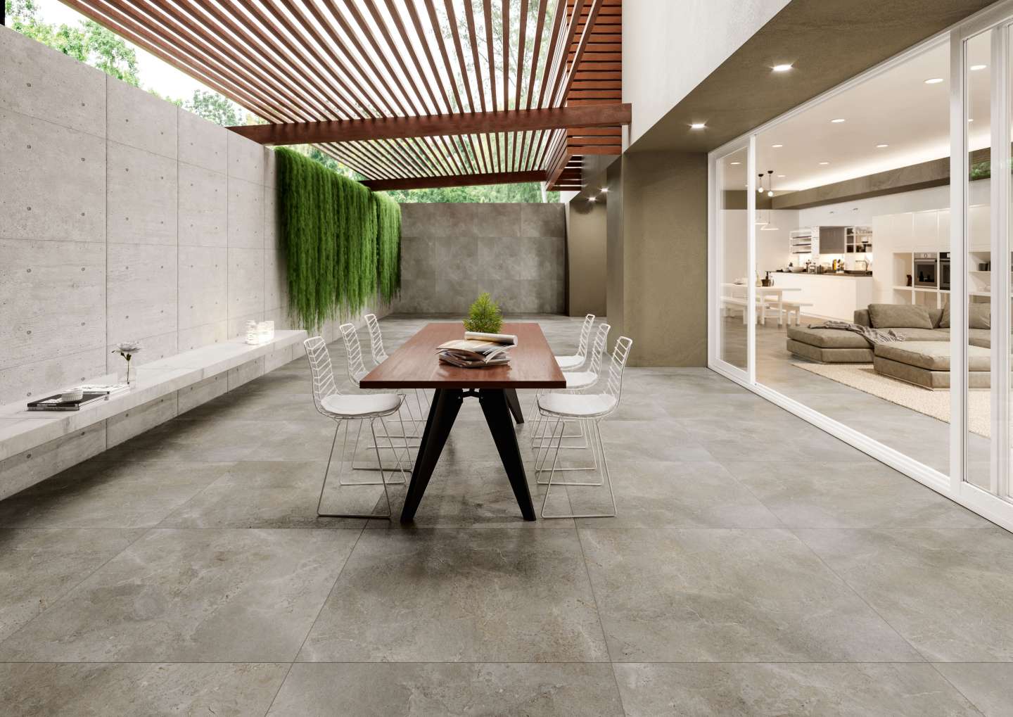 Großformatige graue Outdoor-Fliesen auf einer modernen Terrasse mit Pergola und Blick ins Wohnzimmer.