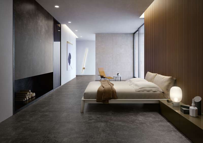 Elegantes Schlafzimmer mit großformatigen dunklen Bodenfliesen.