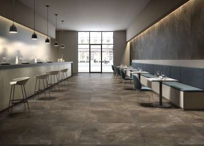 Elegante, großformatige Bodenfliesen in dunklem Farbton für moderne Innenräume wie Restaurants.