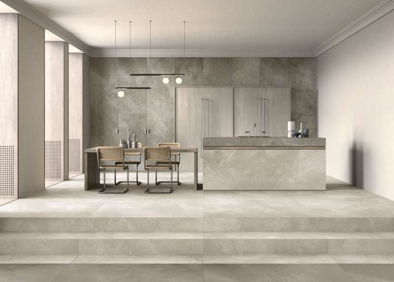 Elegante Küche und Essbereich mit großformatigen Fliesen in Betonoptik von Porcelaingres.