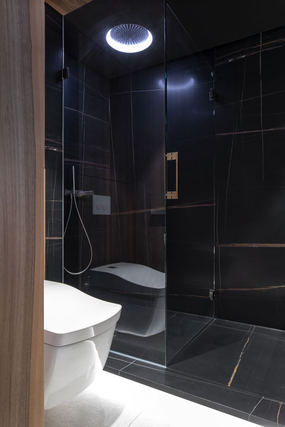 Schwarze Porcelaingres Fliesen in Marmoroptik für ein luxuriöses Bad.