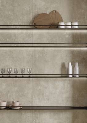 Helle Wandfliesen in Betonoptik mit beleuchteten Regalen und Küchenaccessoires.